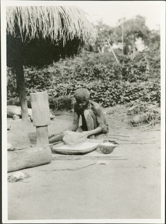 Zande woman sifting manioc flour