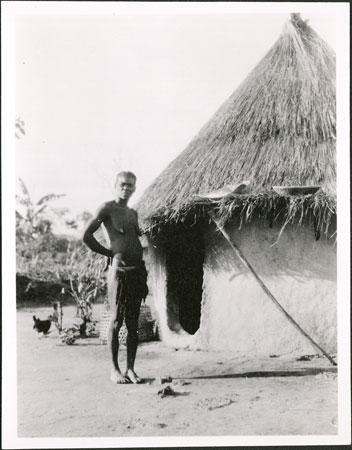 Zande woman outside hut