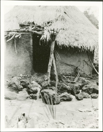 Zande spirit-shrine with grave stones