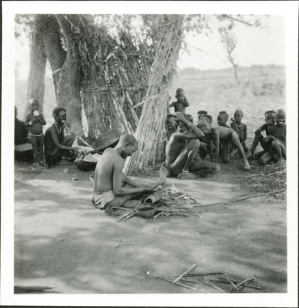 Anuak woman weaving basket