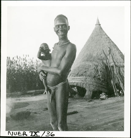 Nuer man with baby