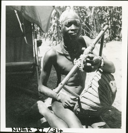 Nuer youth playing harp