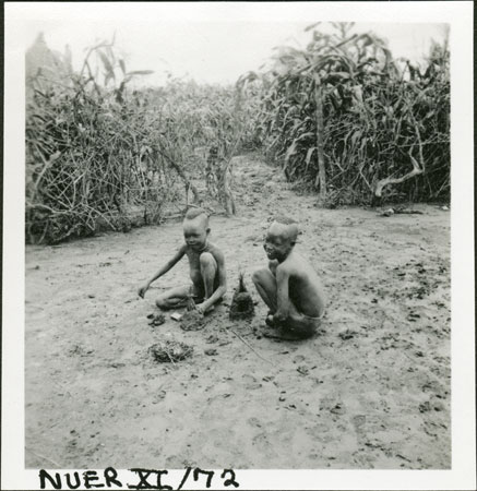 Nuer boys making clay byres