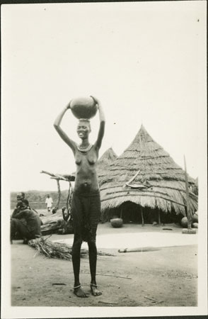 Nuer woman holding vessel