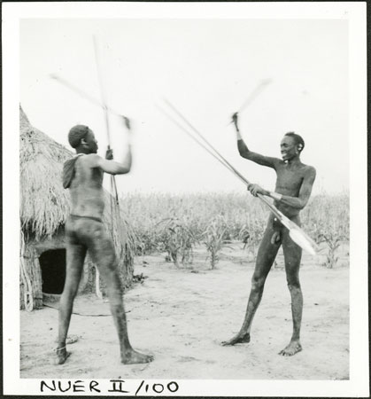 Nuer men with clubs