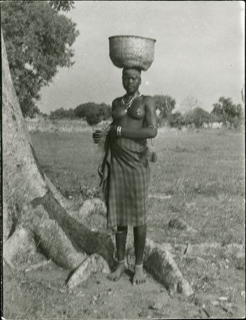 Mandari woman carrying basket on head