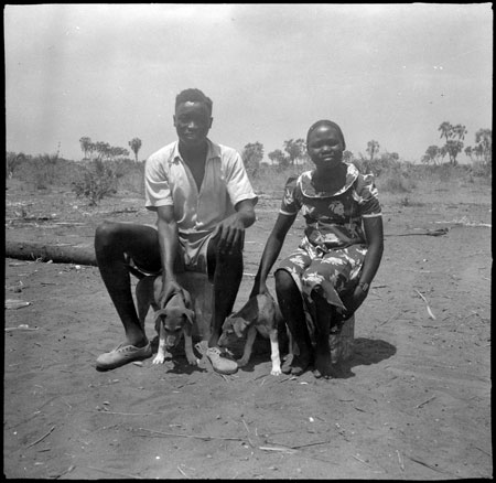 Portrait of Mandari couple with dogs