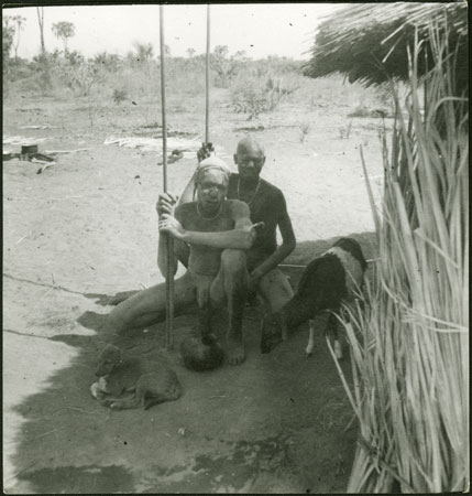 Mandari youths seated in hut shade