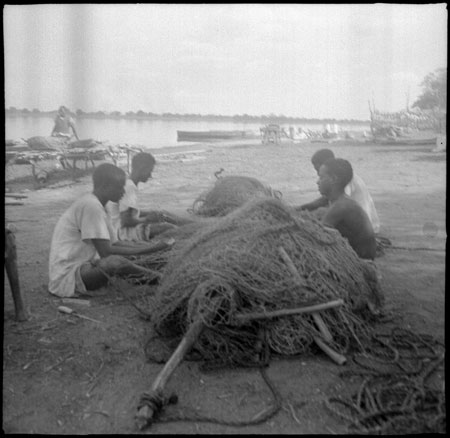 Fishermen mending nets in Mandari