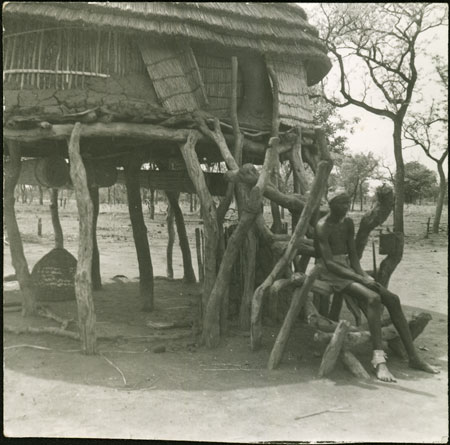 Mandari hut with youth on steps