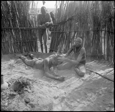 Mandari youths cleansing with ash
