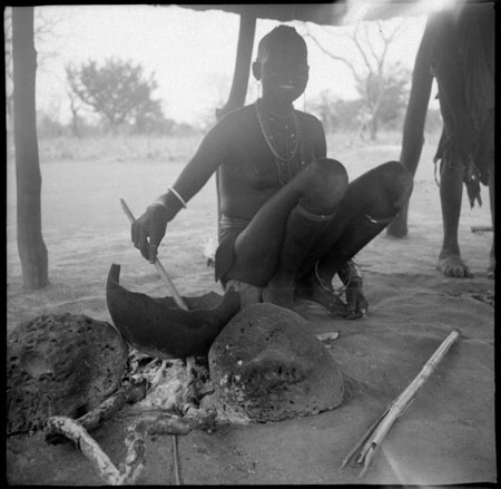 Mandari woman preparing food