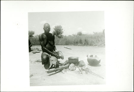 Mandari woman preparing food