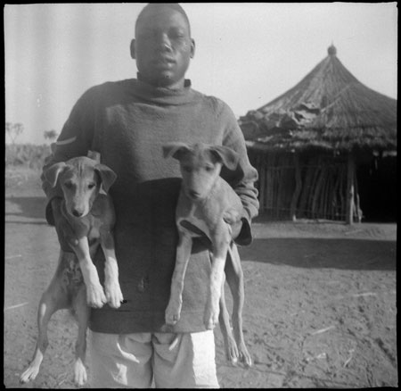 Mandari boy with puppies