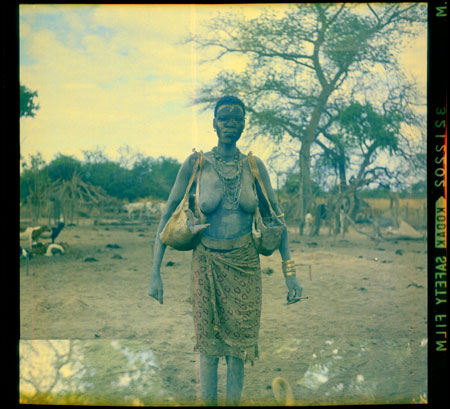 Mandari woman carrying babies in bags