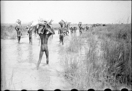 Nuer porters in stream