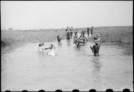 Nuer porters in stream