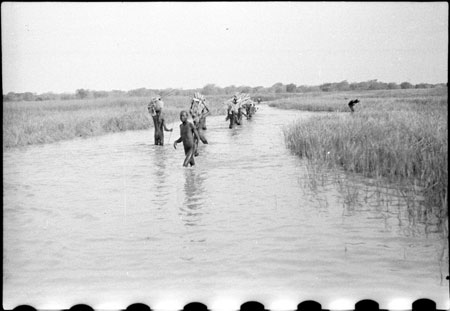 Nuer porters in stream