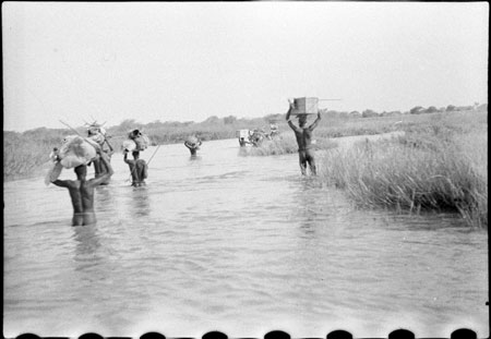 Nuer porters in stream