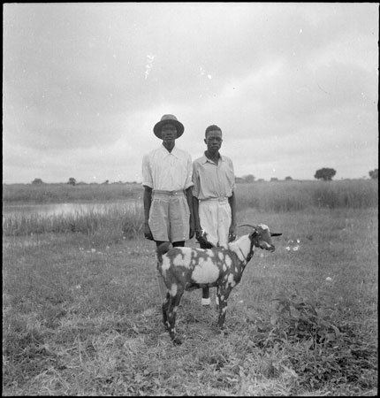 Dinka men with goat