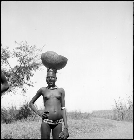Dinka woman with gourd vessels
