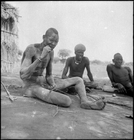 Dinka man making rope