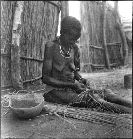 ?Anuak woman weaving rope