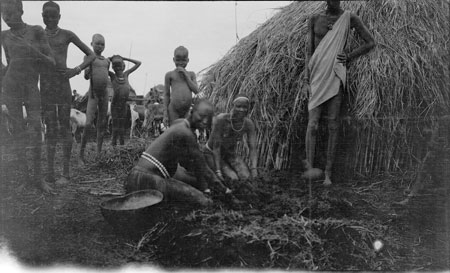 Nuer woman preparing mixture