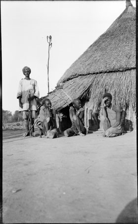 ?Nuer women outside hut