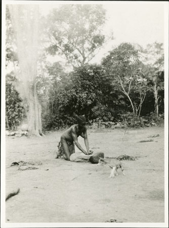 Zande woman grinding flour