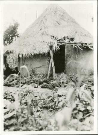 Zande spirit-shrine with grave stones