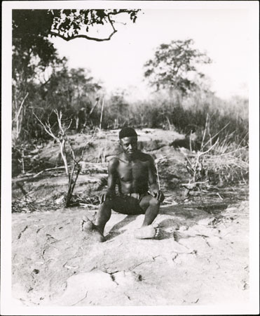 Zande youth seated on rock