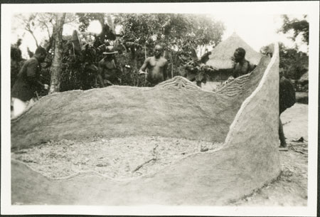 Building clay wall of Zande hut