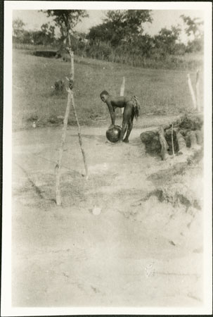 Zande woman collecting water