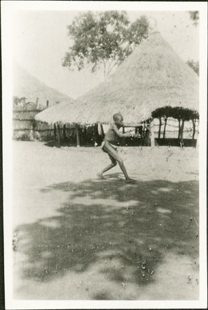 Zande boy playing boomerang game