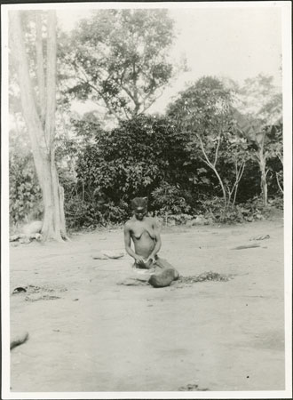 Zande woman grinding flour