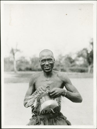 Zande man weaving hat