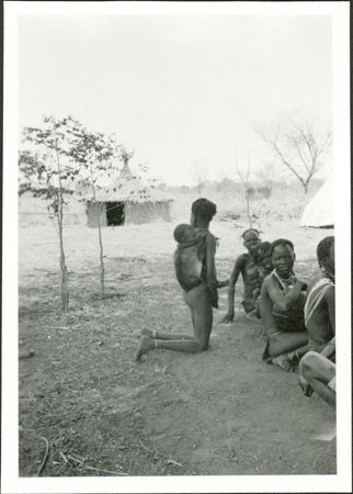 Anuak girl carrying baby