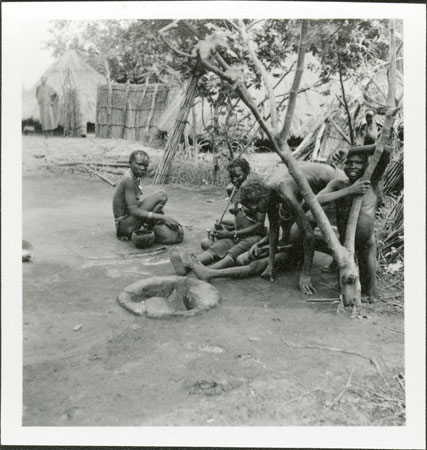 Anuak women around fireplace