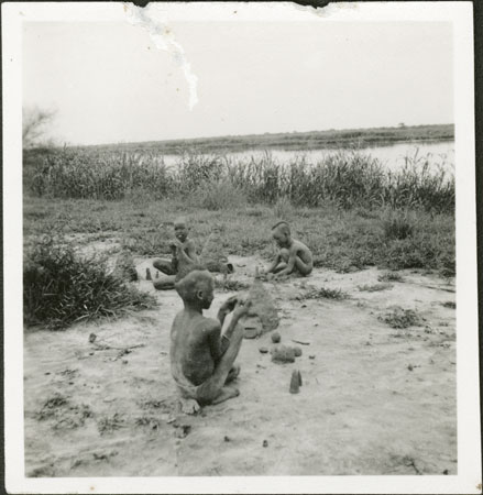 Nuer boys making mud byres