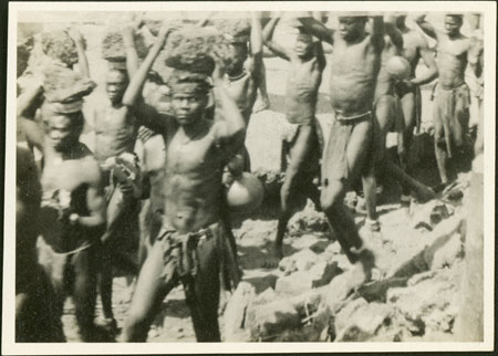 ?Moro men carrying rocks