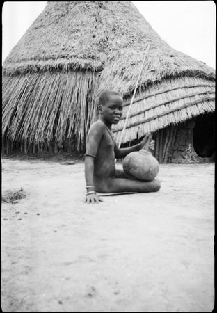 Nuer girl churning milk