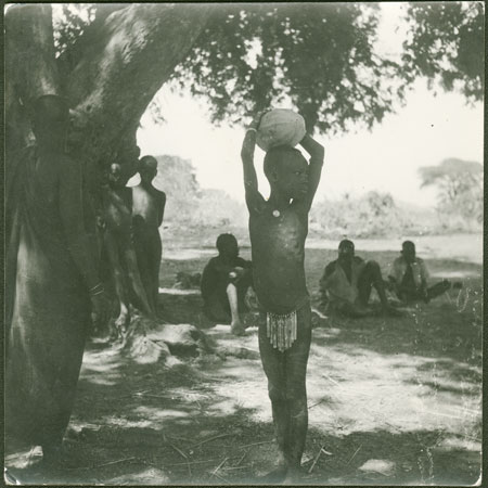 Mandari girl carrying melon