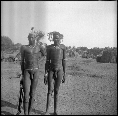 Two Mandari men wearing beads