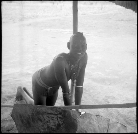 Mandari woman preparing food