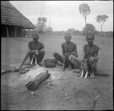 Mandari men around hearth