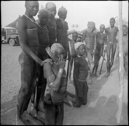 Mandari youths wearing bead ornaments