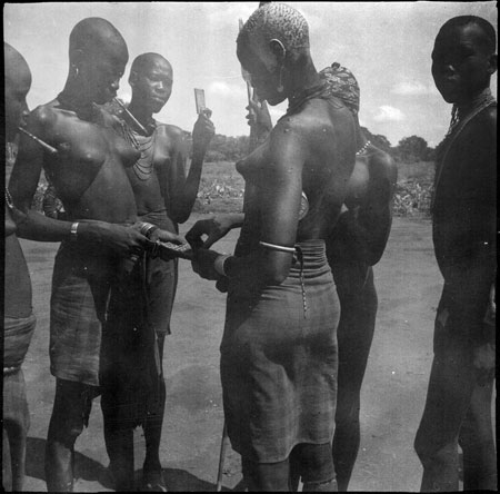 Mandari women handling beads