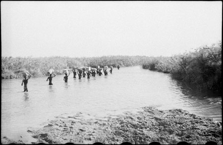 Nuer porters in stream