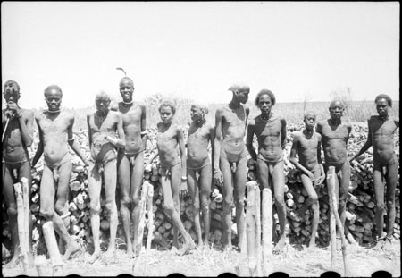 Nuer men with fuelwood